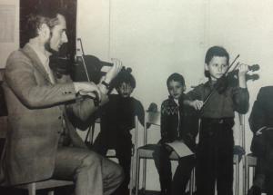 András Nagy playing violin with his father